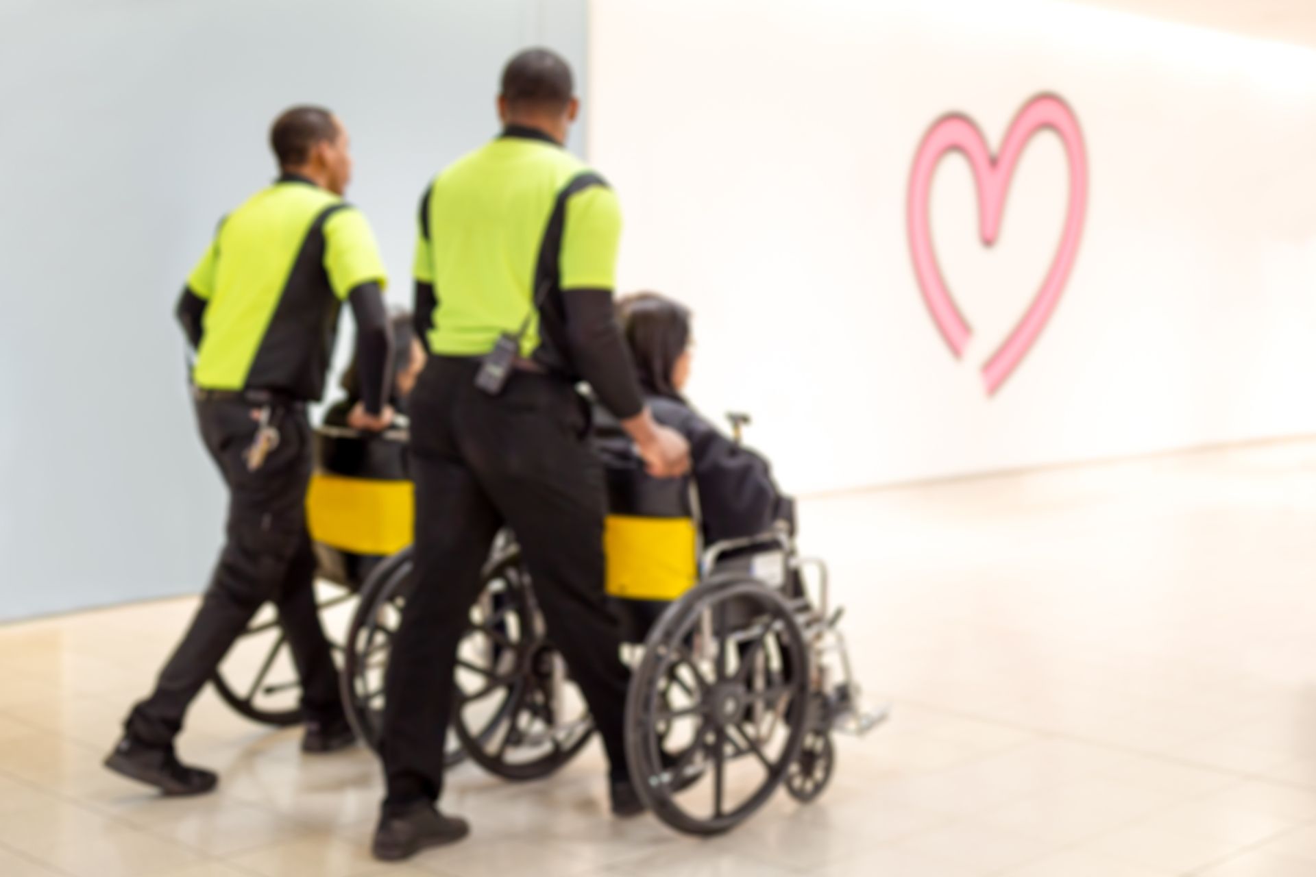 Blurred concept caretaker pushing elderly people in wheelchair in the airport