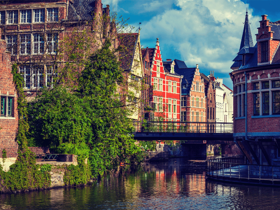 The canal with the red bricked gothic buildings in Ghent. 