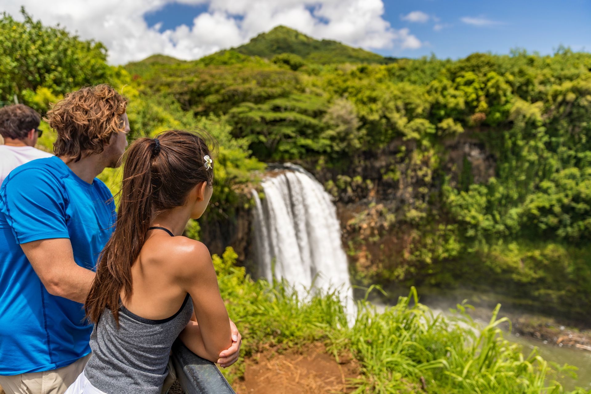 Couple Tourists at Hawaii Kauai Waterfall