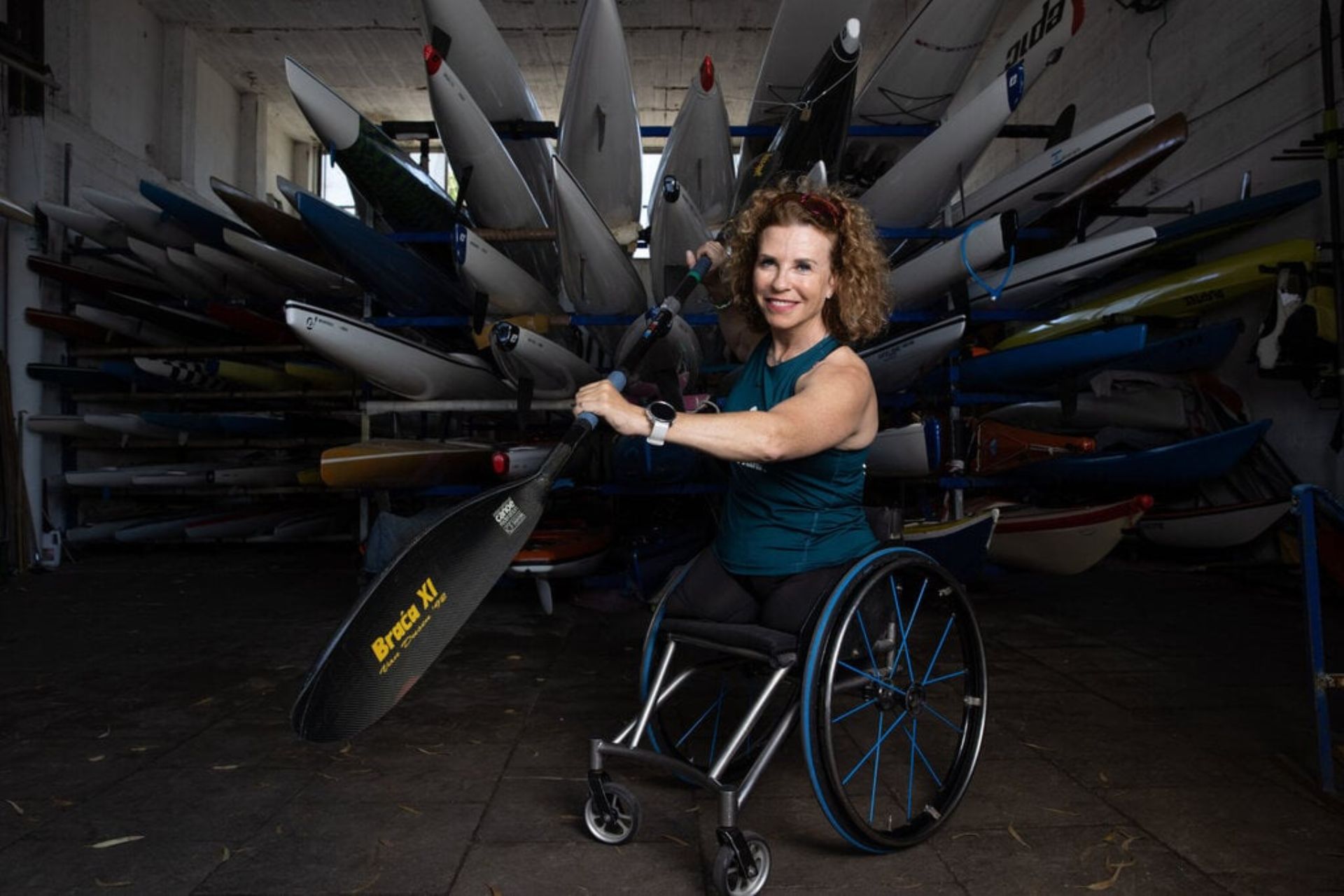 Pascale Bercovitch holding oars smiling at the camera