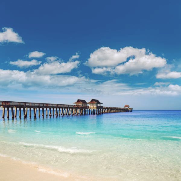 Naples Pier and beach in Florida USA sunny day