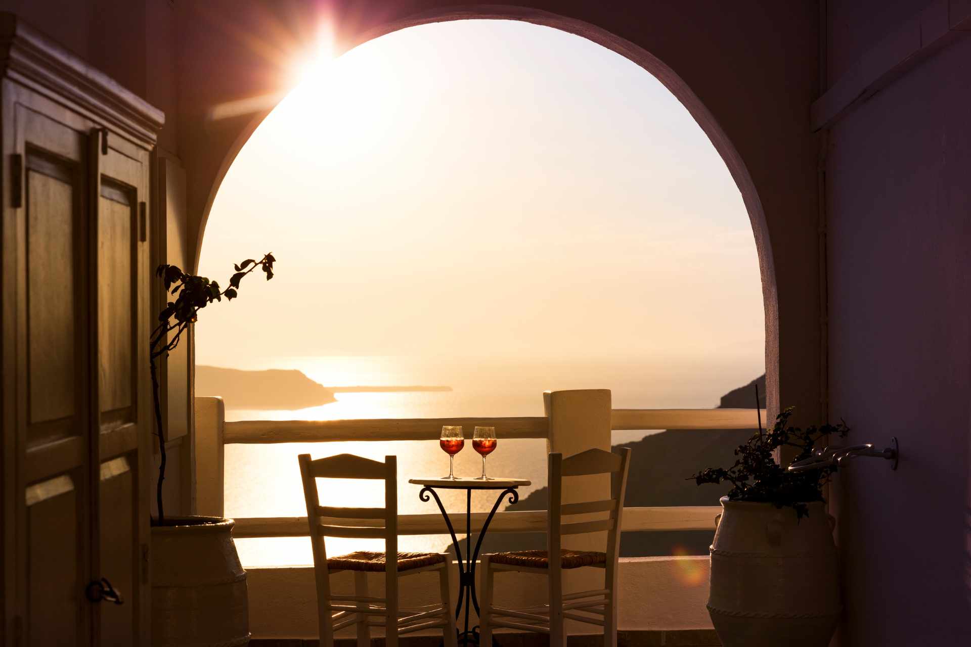 Santorini sunset with two glasses of Santo Wine.