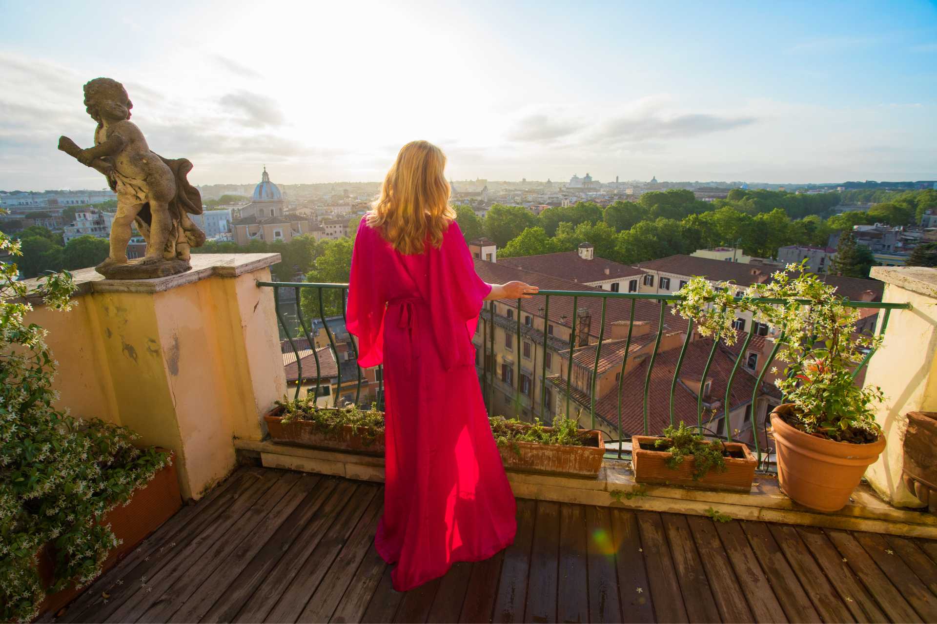 Woman in Red Robe Standing on Balcony