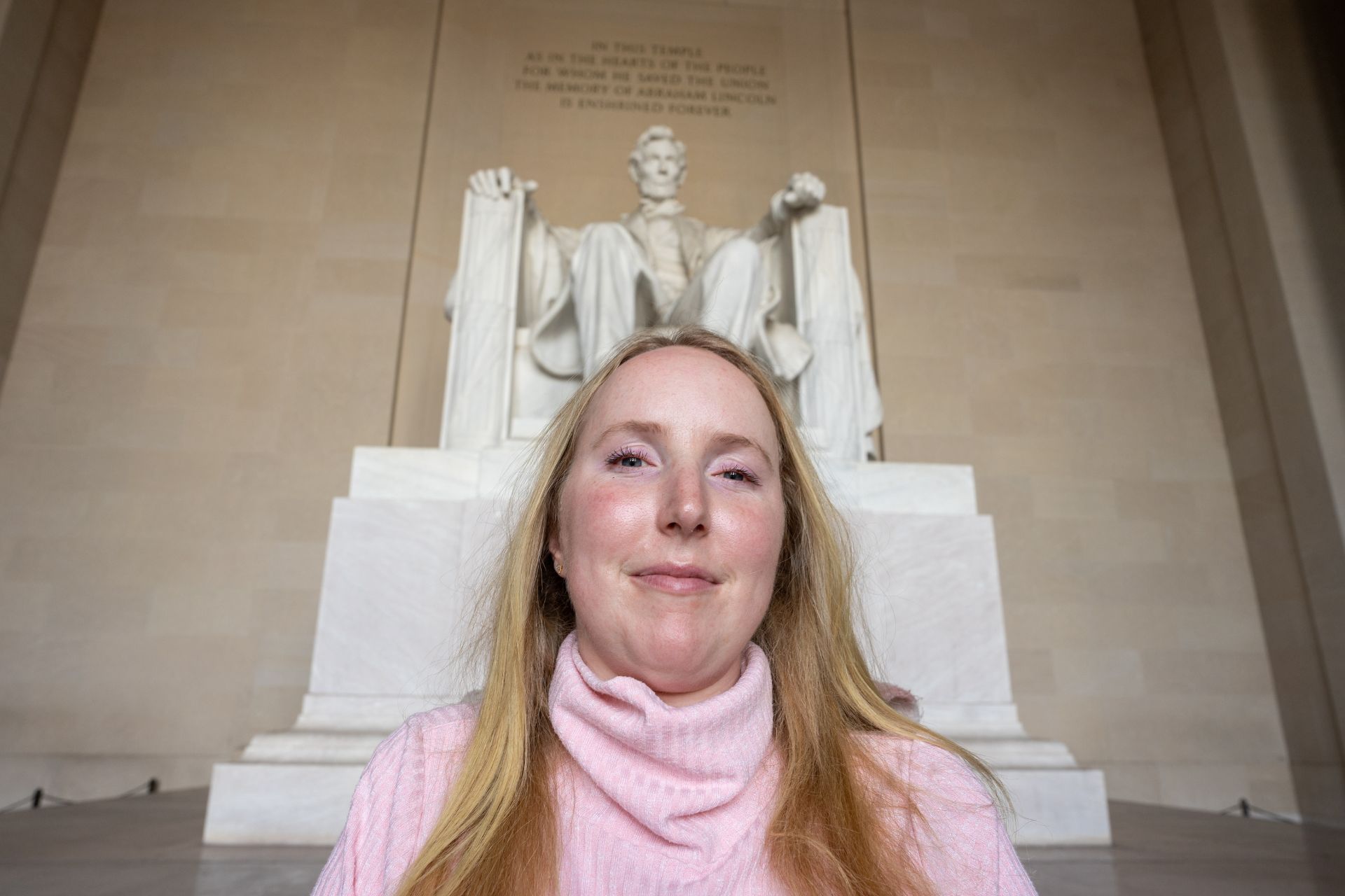 Grace Fisher sitting in front of the Lincoln Memorial in Washington D.C