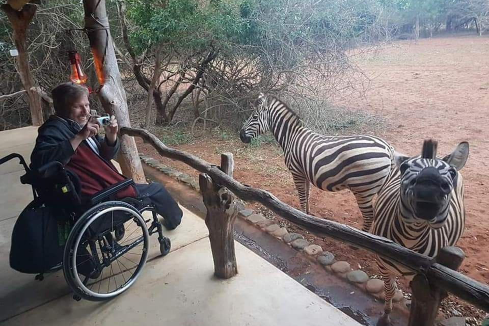 A man in a wheelchair taking pictures on a Inclusive African Safaris with Access 2 Africa Safaris
