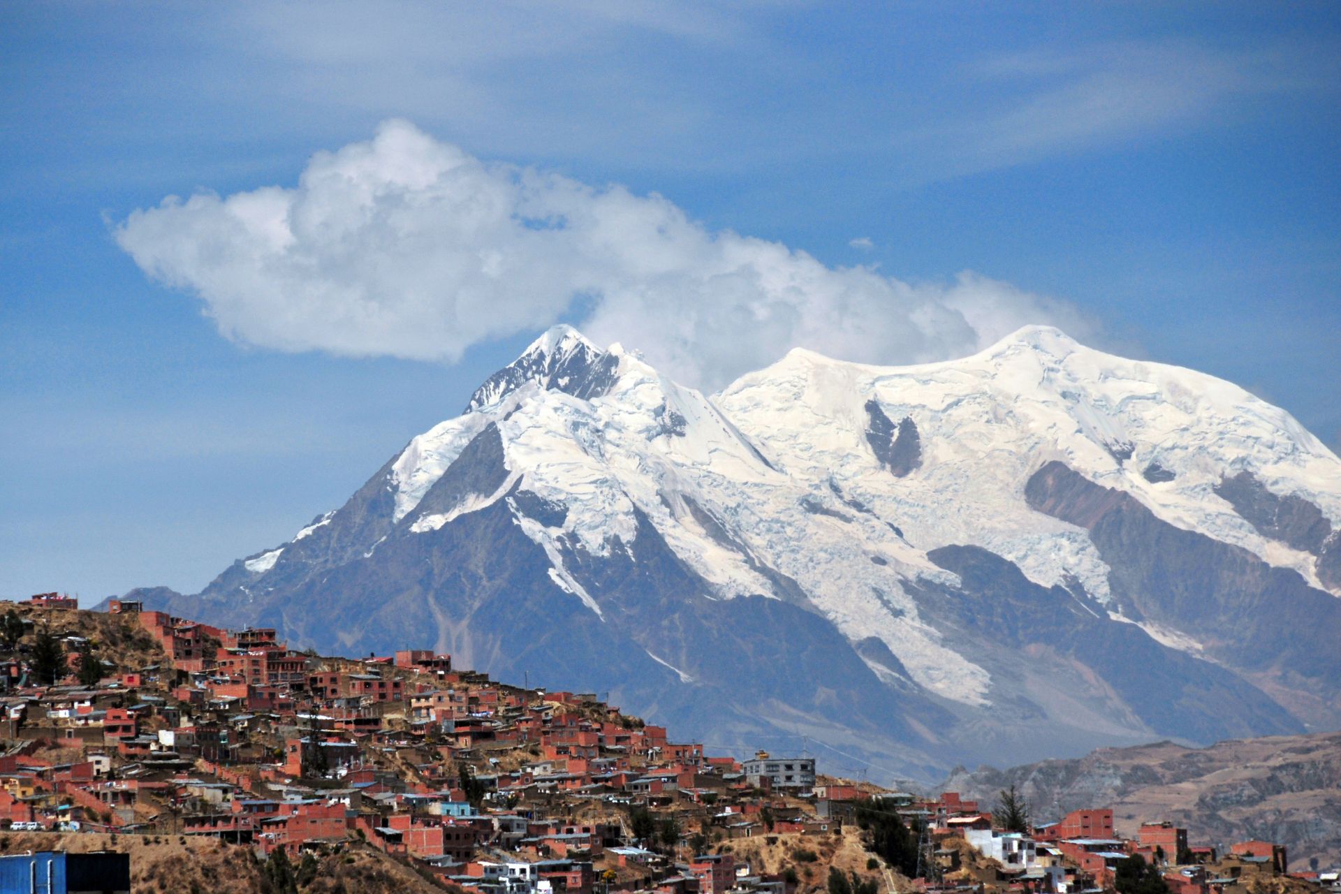 La Paz, Bolivia: southern suburbs and mount llimani - orogenic cloud formation - photo by M.Torres