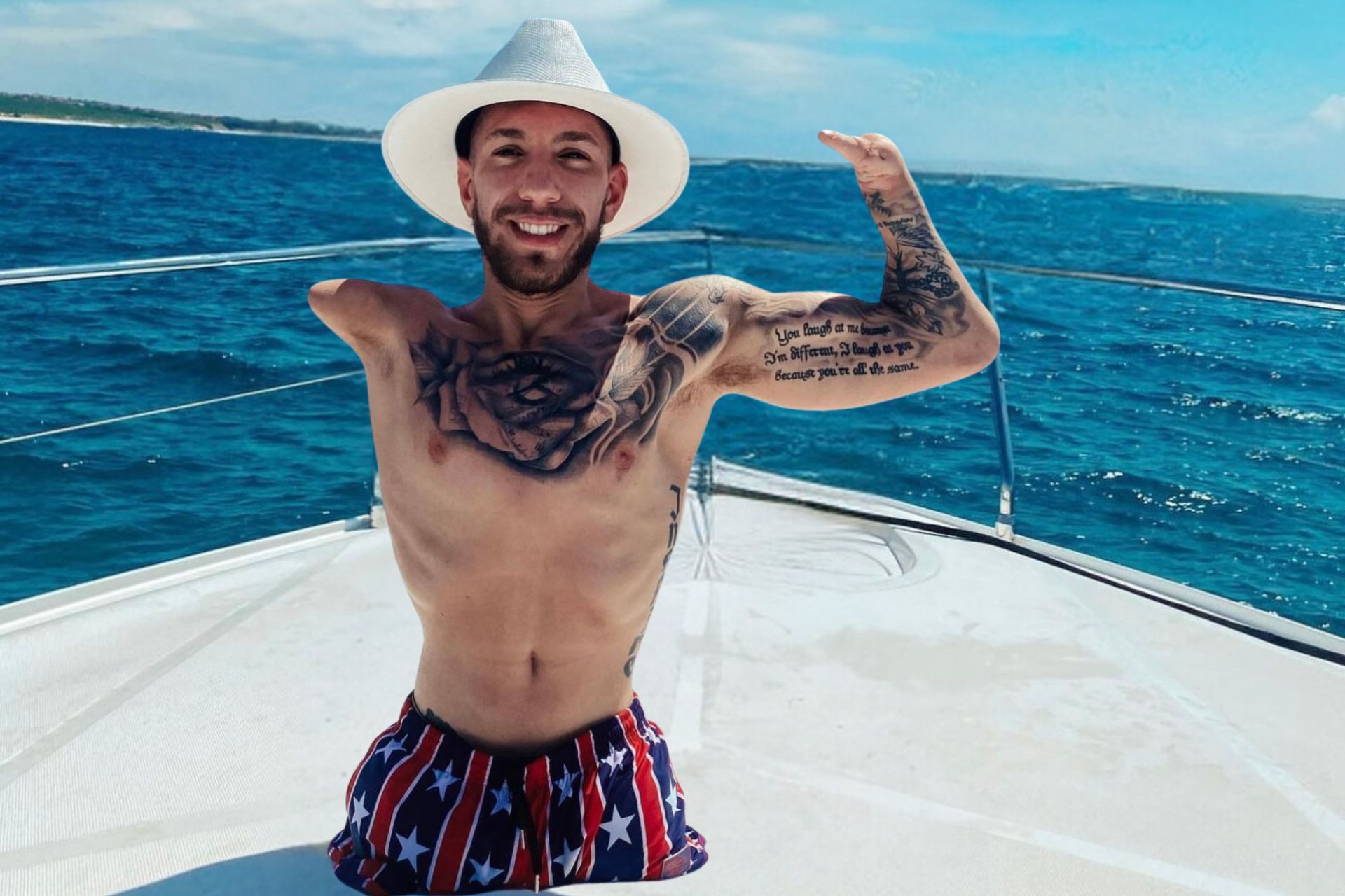 Nick Santonastasso on the hull of a boat, smiling at the camera