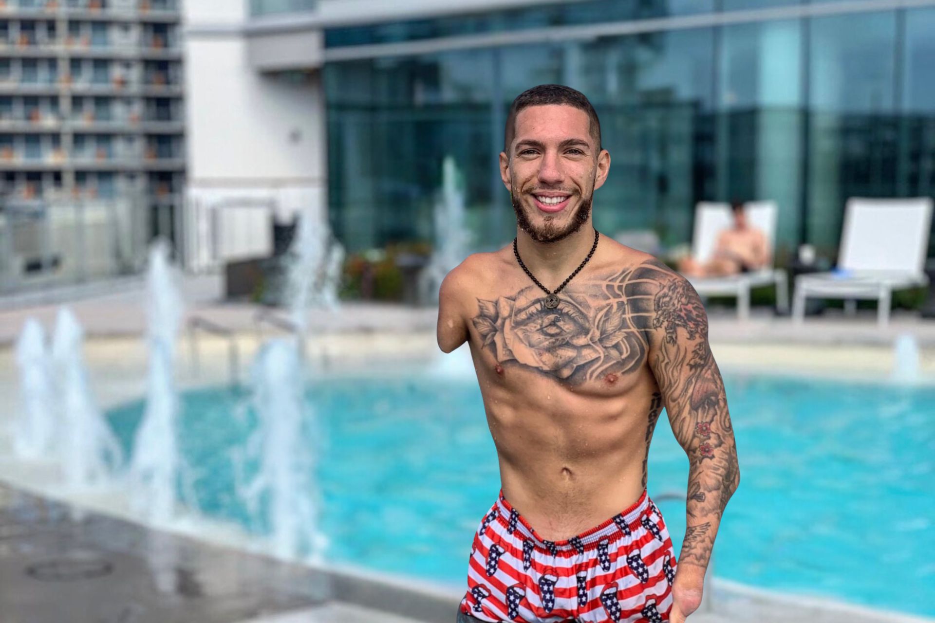 Nick Santonastasso smiling in front of a hotel pool