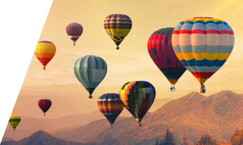 Colourful hot air ballons flying over mountains tops