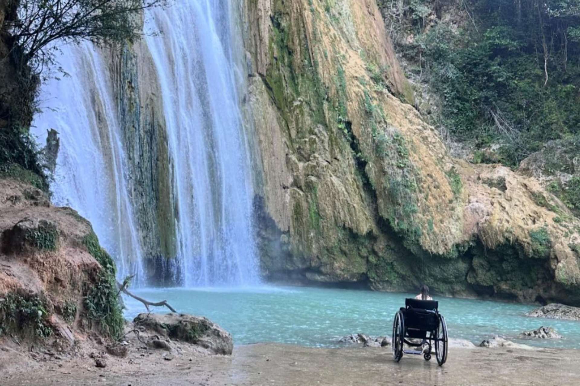GK wheelchair parked up at the waterfall in DR, Caribbean